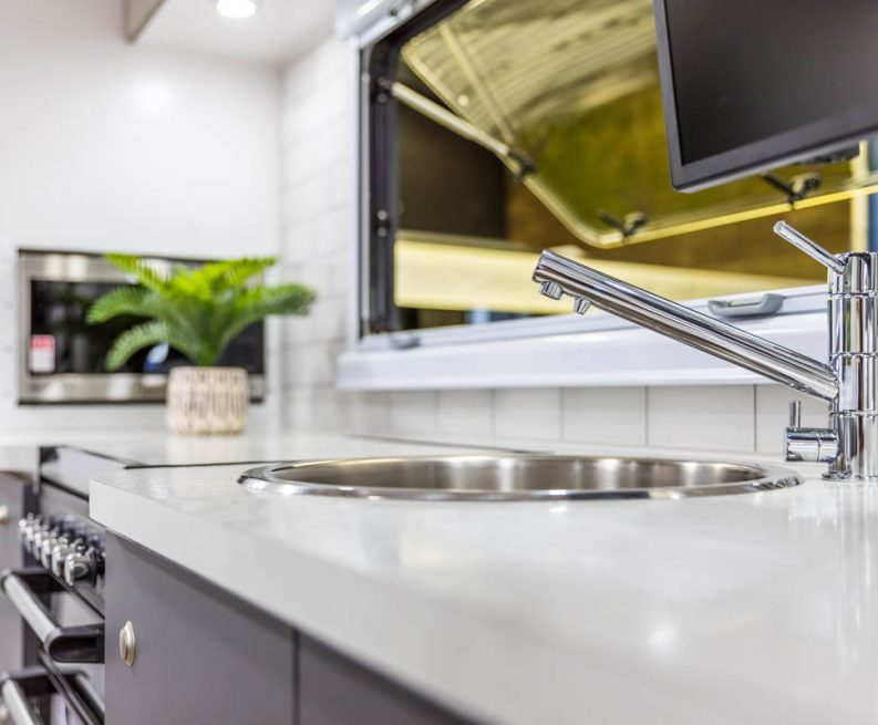 The kitchen benchtop in a Bushtracker Caravan for sale in Coffs Harbour